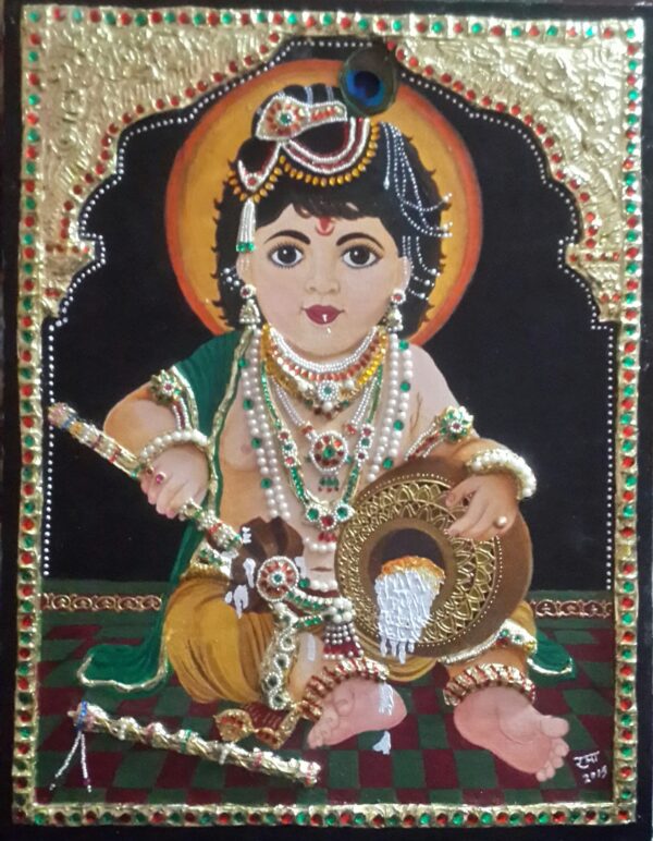 This Tanjore painting portrays the beloved deity Bal Gopal (Baby Krishna) in a serene yet playful pose. Richly adorned with traditional jewels, pearls, and golden ornaments, Krishna is depicted holding a butter pot, a nod to his legendary fondness for butter. The vibrant colors, intricate detailing, and use of gold foil enhance the divine aura of the artwork. The background, framed with ornate patterns, adds depth and highlights Krishna’s celestial charm, making this a masterpiece of devotion and craftsmanship.